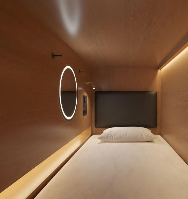 NOHO capsule interior with a private bed, warm timber and softly lit mirror